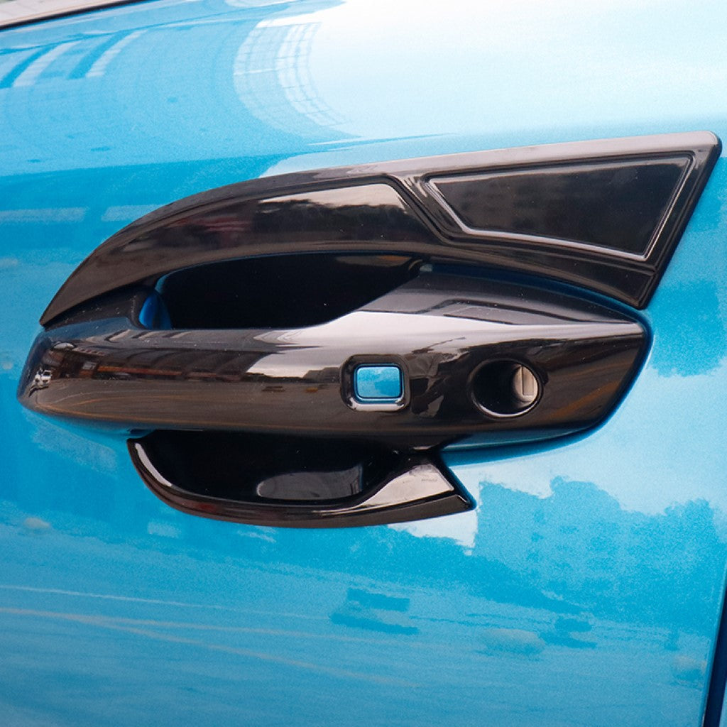 BYD ATTO 3 Door Handle Bowl Panel Covers in glossy black ABS fitted on a blue electric vehicle door handle.