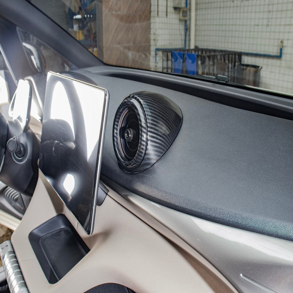 BYD Dolphin Centre Air Vent Cover in imitation carbon fibre installed on electric car dashboard with touchscreen display