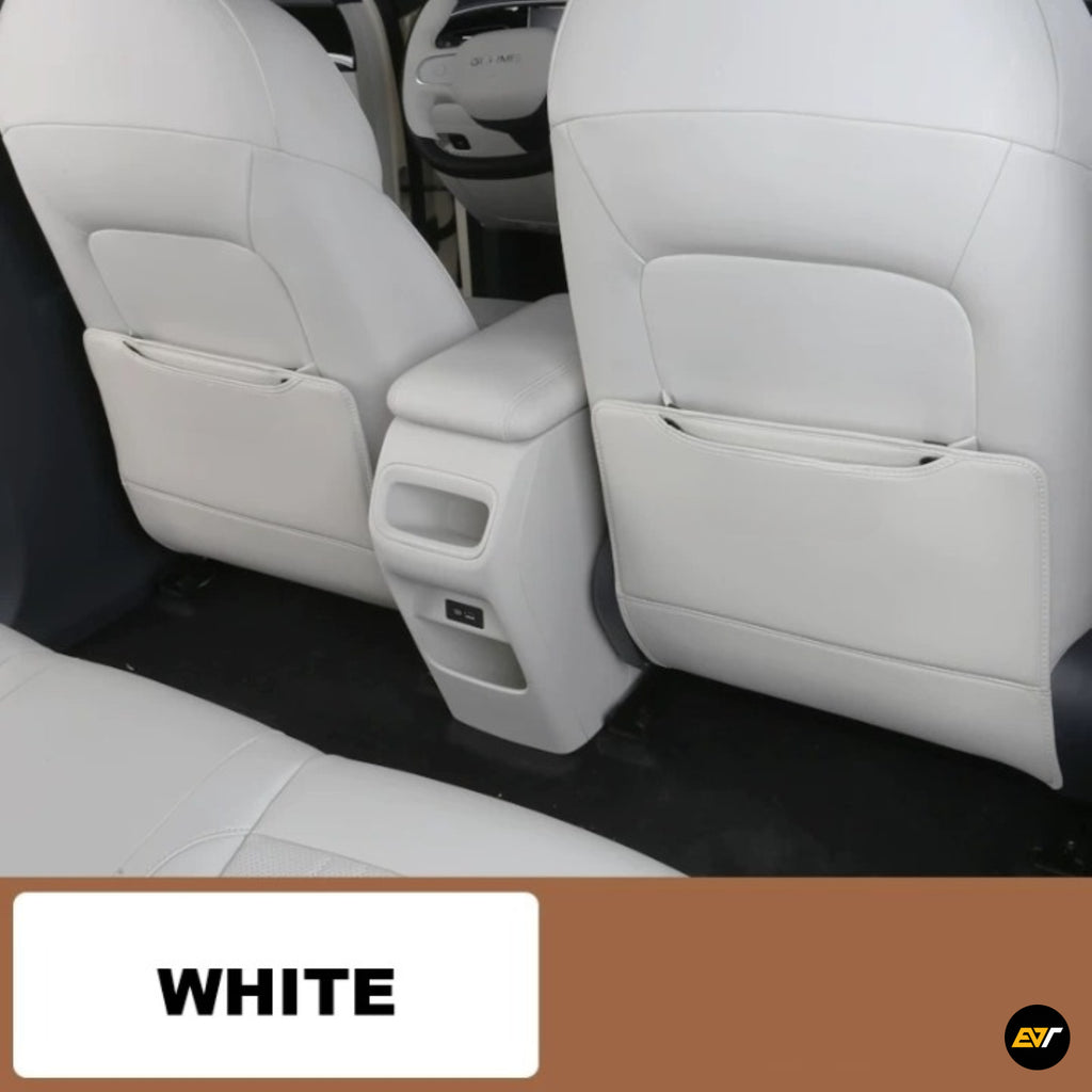 White car rear seat covers with integrated storage pockets and a central armrest console in a clean white finish