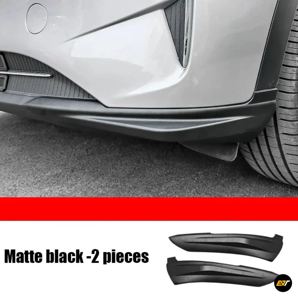 White car rear bumper with matte black lower trim fitted, alongside two matching black exterior styling pieces; two pieces shown