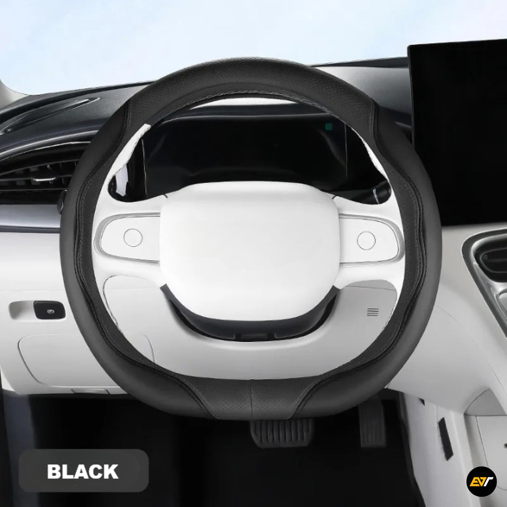 Black steering wheel cover fitted over a white steering wheel in a modern car interior