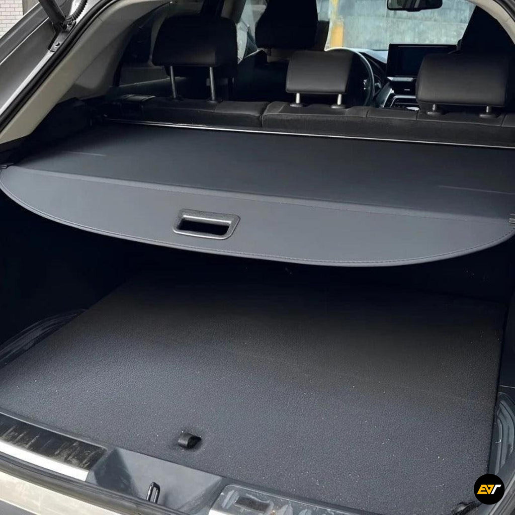 Black retractable car boot parcel shelf providing a neat cover for the rear luggage compartment and cargo area