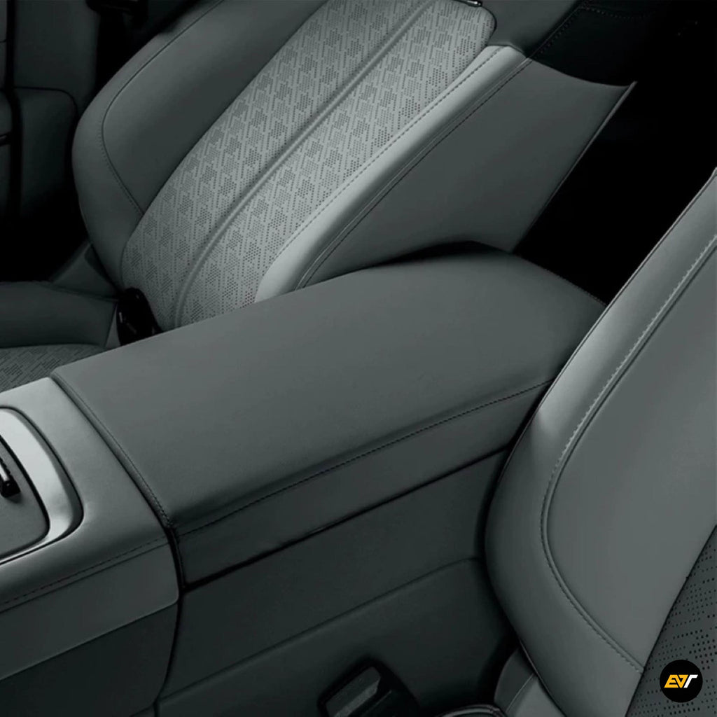 Luxurious grey protective cover fitting the centre armrest box in a modern electric vehicle interior