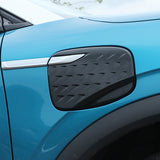 BYD ATTO 3 Charging Port Protection Cover installed on blue electric vehicle, showcasing sleek protective design.