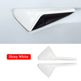 A white car door handle with a black handle, featuring seamless integration for the Tesla Model 3/Y Side Camera Lens Protector.