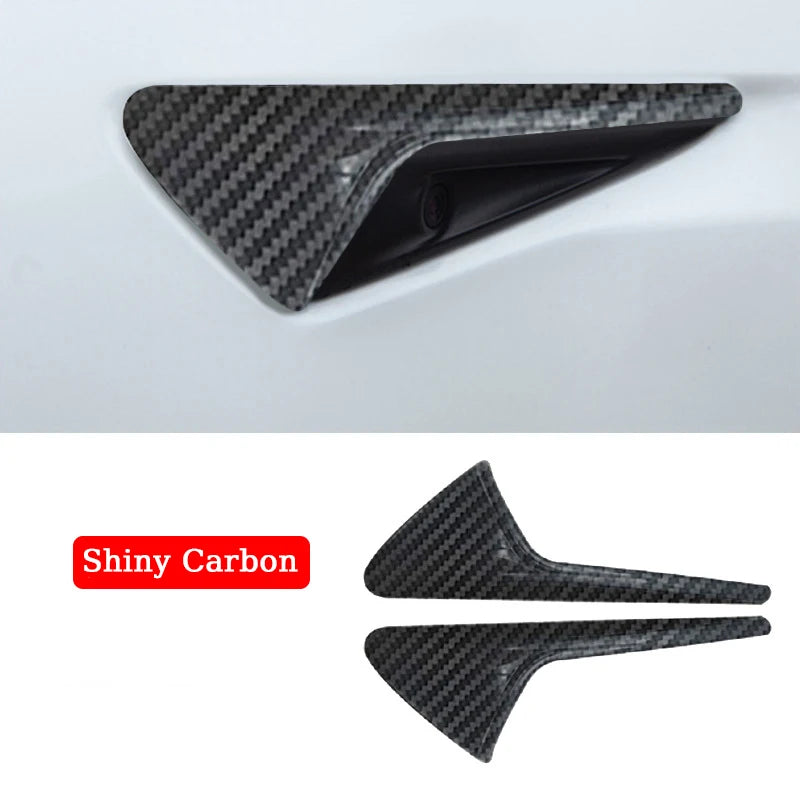 A pair of carbon fiber door handles with a seamless integration for a Tesla Model 3/Y Side Camera Lens Protector.
