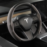 The steering wheel of a Tesla Model 3/Y Steering Wheel Cover offers a non-slip grip.