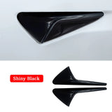 A pair of black door handles with a shiny black finish designed for seamless integration on the Tesla Model 3/Y, including a Tesla Model 3/Y Side Camera Lens Protector.