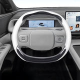 XPENG G6 Anti Slip Leather Steering Wheel Covers installed, showing white and carbon fiber design inside electric vehicle.