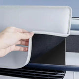 Hand holding a white protective cover showing soft inner lining designed for a car navigation screen accessory