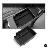 Black centre console organiser tray with multiple compartments for vehicle storage accessories inside car armrest compartment