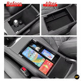 Car centre console organiser tray showing before and after installation with storage compartments in black interior