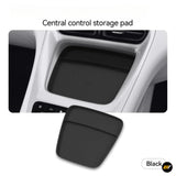 Black central control storage pad shown in a vehicle centre console with a textured non slip surface