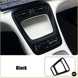Black automotive centre console surround with air vents, storage compartment and gear selector visible