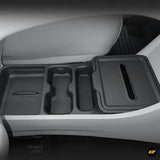 Black centre console organiser tray with cup holder and storage compartments fitted inside an electric vehicle interior