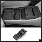 Black centre console storage organiser tray with cup holders and covered compartment shown installed in a vehicle and separately