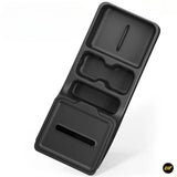 Black moulded vehicle storage organiser tray with multiple recessed compartments and an elongated slot for convenient interior storage
