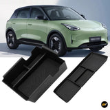 Green electric car with black moulded storage trays displayed in the foreground for vehicle interior organisation