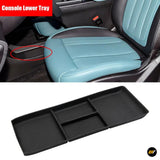 Black lower centre console tray shown in a car interior with a separate organiser tray for vehicle storage