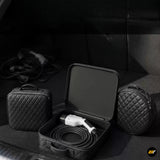 Portable electric vehicle charging cable and connector in an open protective case with two quilted storage bags
