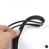 Hand holding a black flexible rubber strip with a looped cable on a white background