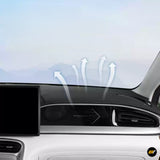 Black car dashboard air vent with airflow arrows beside a central display, showing vehicle ventilation direction