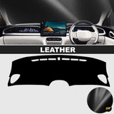 Black leather dashboard cover shown fitted inside a modern car, with cutouts for vents and display screen വ്യക്തമാക്കി