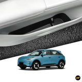 Car door storage pocket shown above a blue electric crossover vehicle, highlighting practical interior storage for EV owners