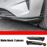 White car rear bumper with matte black lower trim fitted, alongside two matching black exterior styling pieces; two pieces shown