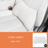 White lumbar support cushion with contoured ergonomic design positioned on a light leather car seat for added back comfort