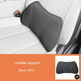 Black lumbar support cushion fitted to a white car seat for ergonomic lower back support and improved driving comfort