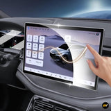 Car dashboard touchscreen display with a hand applying a clear protective film over the vehicle infotainment screen