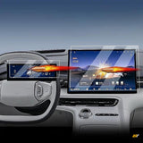 Electric vehicle dashboard with steering wheel display and large central touchscreen, both shown with protective screen film outlines