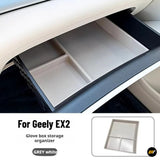 Grey and white glove box storage organiser shown inside a Geely EX2 dashboard compartment