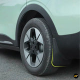 Close-up of an electric vehicle wheel with a five-spoke alloy rim, black wheel arch trim and bright yellow lower body accent