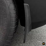 Close-up of a black vehicle mud flap fitted behind a tyre to help protect the wheel arch from road spray and debris