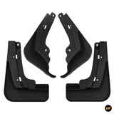 Set of four black vehicle mud flaps with mounting holes and shaped splash guards displayed against a white background