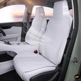 White fitted car seat covers protecting the front seats of a modern electric vehicle interior in a clean tailored finish