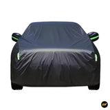 Black protective car cover with green reflective accents and exposed side mirrors shown from the front