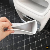 Hand removing a white removable tray from a compact vehicle accessory on a black quilted surface