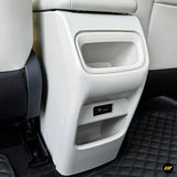 White rear car seat centre console organiser with two storage compartments and a USB charging port in a light interior