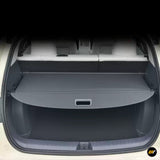 Electric vehicle boot with a fitted retractable parcel shelf and spacious rear cargo area in dark grey interior