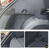 Close-up of a black vehicle boot side panel with textured grille, trim hooks and fitted interior fastening details