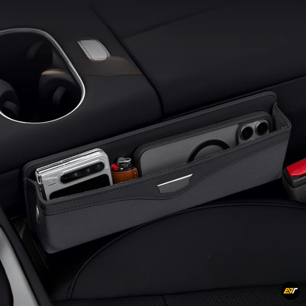Black vehicle seat storage organiser with smartphone and small bottle in multiple compartments