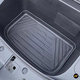 Black moulded rubber boot liner with raised edges and grooved tread pattern fitted in a vehicle storage compartment