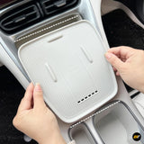 White ribbed centre console tray with raised edges being fitted inside a car, offering a practical storage insert for vehicle accessories