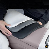 Person holding four layered armrest box covers in white, grey, black, and beige colours for electric vehicles.