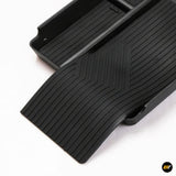 Black rubber centre console armrest storage tray with textured anti-slip surface for vehicle organisation