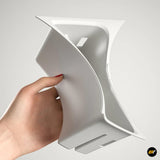 Hand holding white plastic centre console cup holder insert designed for Zeekr electric vehicle accessories