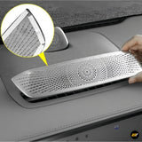Hand installing silver perforated metal air vent cover on Zeekr 7X electric vehicle centre dashboard console